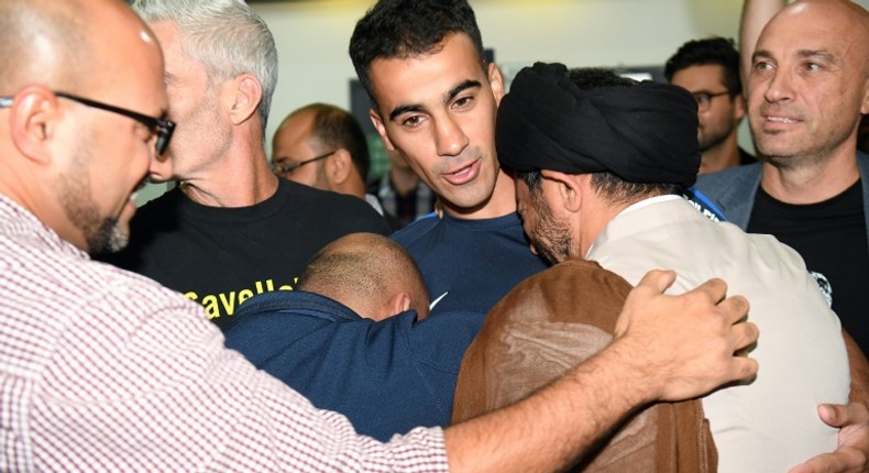 Hakeem al-Araibi (C) was greeted by a throng of well wishers at Melbourne Airport after an overnight flight to freedom