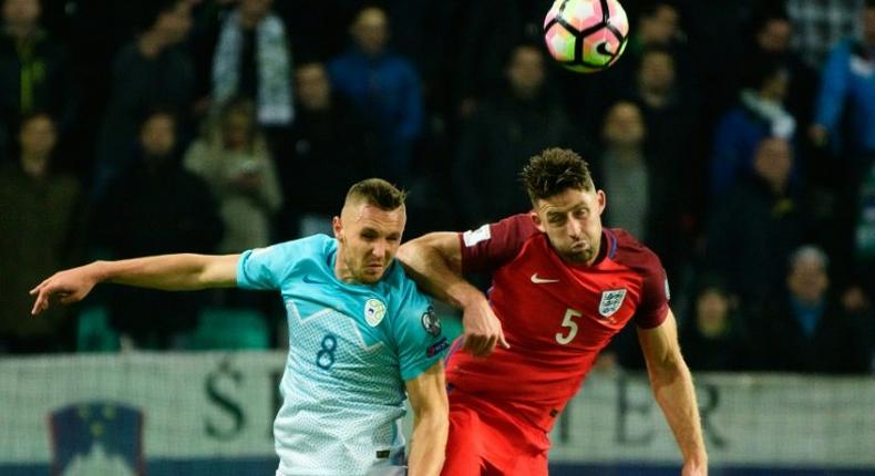 Slovenia's midfielder Jasmin Kurtic (L) vies for the ball with England's defender Gary Cahill (R) during the Fifa World Cup 2018 football qualification match between Slovenia and England on October 11, 2016