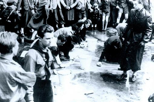 Austrian Jews forced to wash a street in Vienna following the German Anschluss (Annexation) of Austr