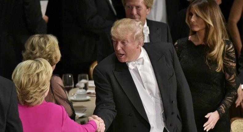 Republican presidential nominee Donald Trump shakes hands with Democratic rival Hillary Clinton during the Alfred E. Smith Memorial Foundation Dinner at the Waldorf-Astoria Hotel in New York, on October 20, 2016