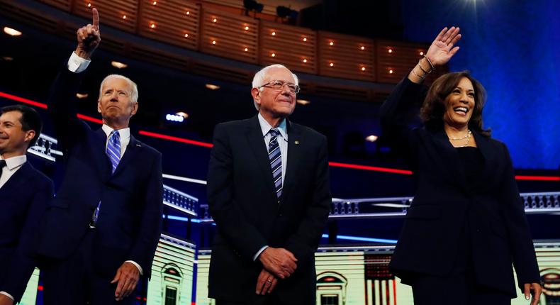 Democratic presidential candidates from left, South Bend Mayor Pete Buttigieg, former vice president Joe Biden, Sen. Bernie Sanders, I-Vt., and Sen. Kamala Harris, D-Calif., gesture before the start of the Democratic primary debate hosted by NBC News at the Adrienne Arsht Center for the Performing Arts, Thursday, June 27, 2019, in Miami. (AP Photo/Brynn Anderson)