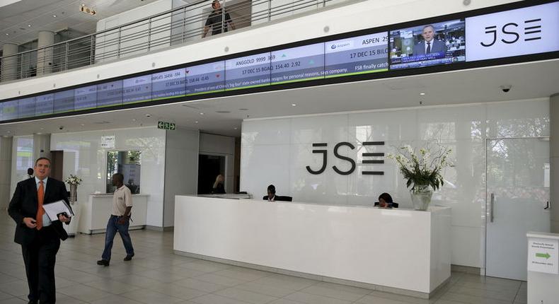 People walk near the reception at the Johannesburg Stock Exchange (JSE) in Sandton, Johannesburg, South Africa December 10, 2015.   REUTERS/Siphiwe Sibeko