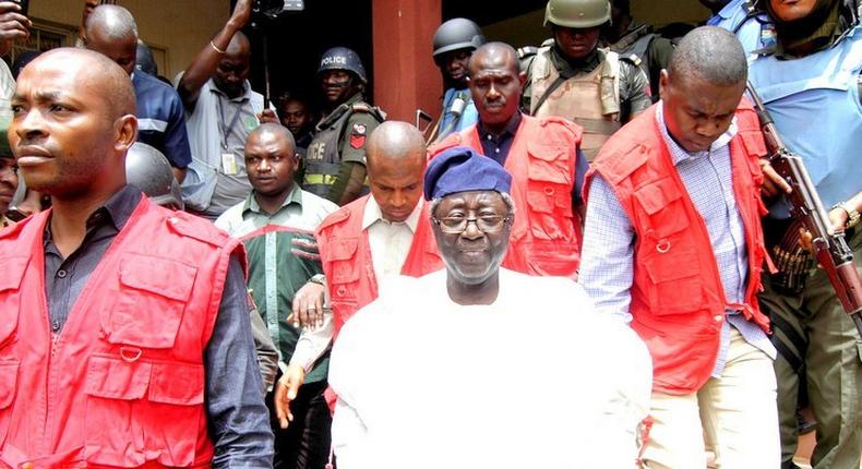 Former governor of Plateau state Jonah Jang being led out of court by the operatives of the Economic and Financial Crimes Commission (EFCC) [premiumtimesng]