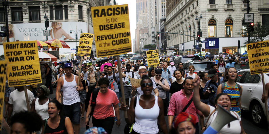 People take part in a protest for the killing of Alton Sterling and Philando Castile during a march along Manhattan's streets in New York July 7, 2016.