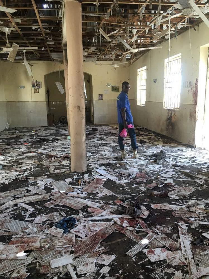 A man inspects the damage inside a mosque at the site of a suicide bomber attack in Mubi in Adamawa 