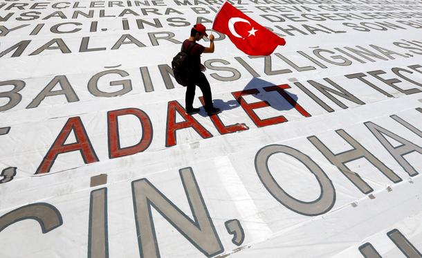 A man walks with a Turkish flag during a rally to mark the end of the main opposition CHP leader Kil