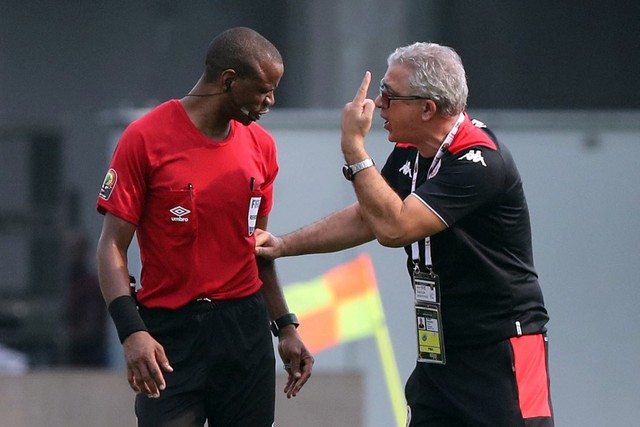 Tunisia manager Mondher Kebaier confronts referee Janny Sikazwe at full-time