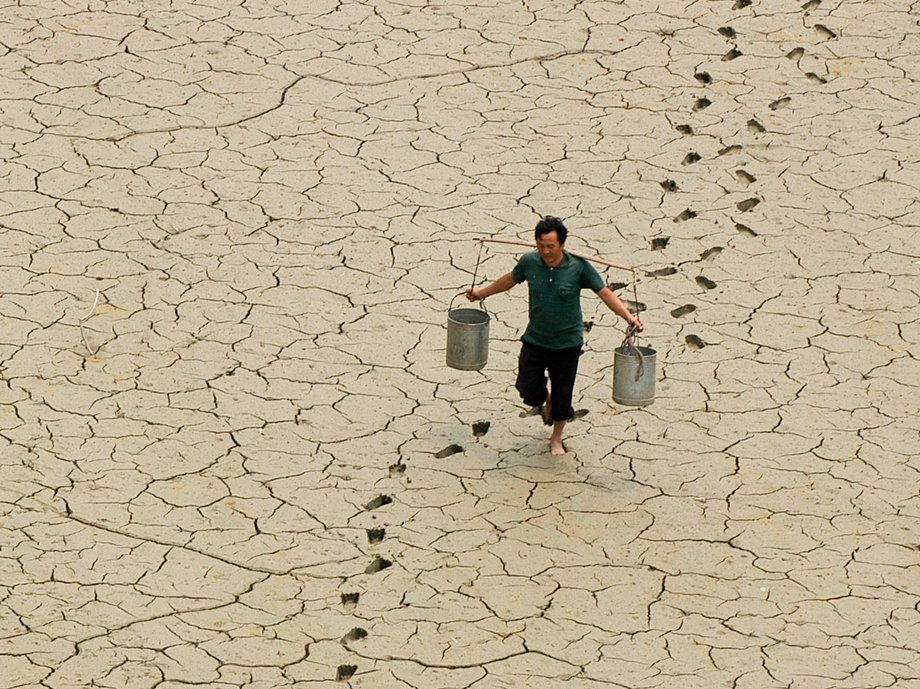 A farmer on a dried-up pond on the outskirts of Baokang in central China's Hubei province.