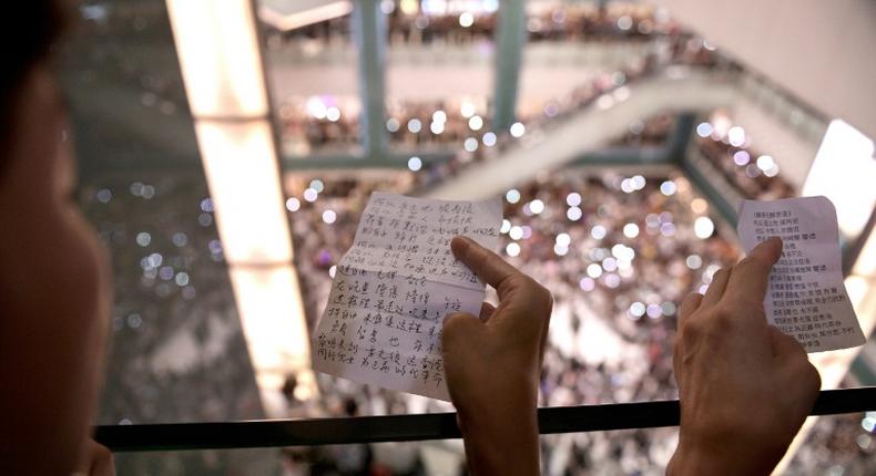 Protesters have gathered at Hong Kong malls to sing a new anthem penned by an anonymous composer