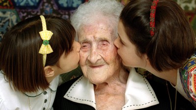 The World's oldest woman, Jeanne Calment, 120 years old, is kissed by two young girls during a speci