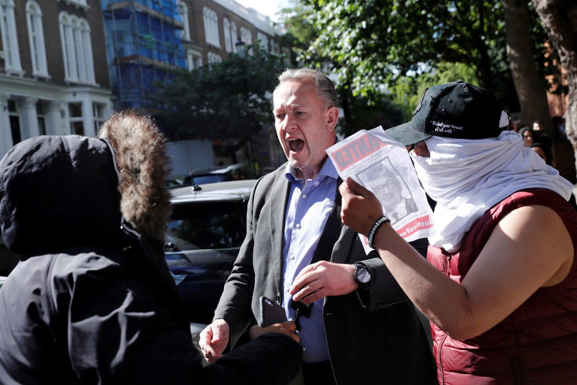 Demonstrators confront a man they believe to be Robert Black, the Chief Executive of KCTMO, outside 