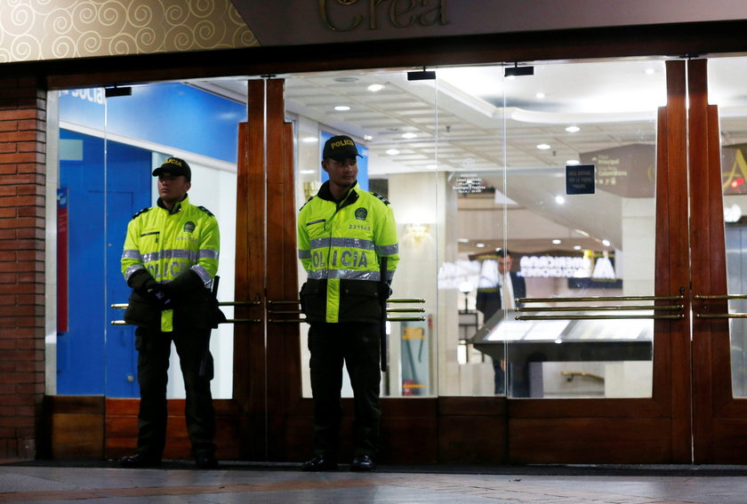 Police officers stand next to escalators inside the Andino shopping center after an explosive device