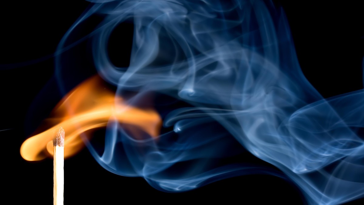 A match creating a flame with smoke