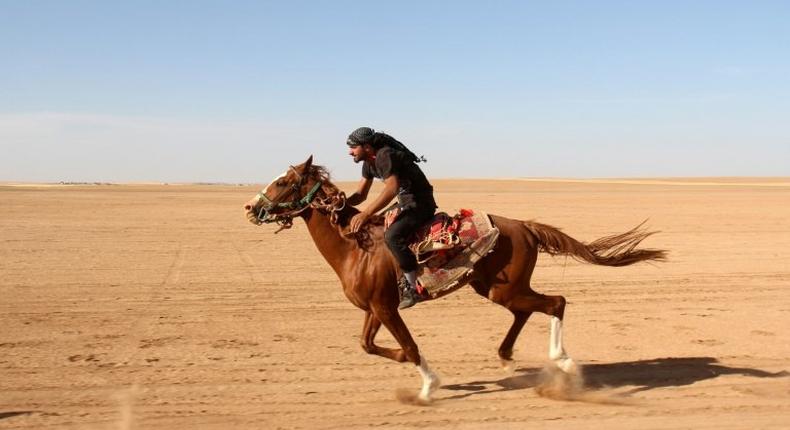 Syrians take part in a horse race for thoroughbred Arabian horses sponsored by Turkish NGO IHH, on May 12, 2017, in the southern Aleppo countryside