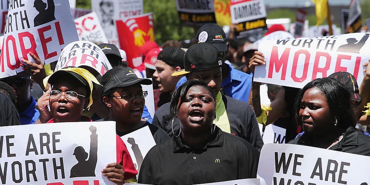 Fast-food workers and activists demonstrate for a $15-an-hour minimum wage and better working conditions outside the McDonald's corporate campus on May 21, 2014, in Oak Brook, Illinois.