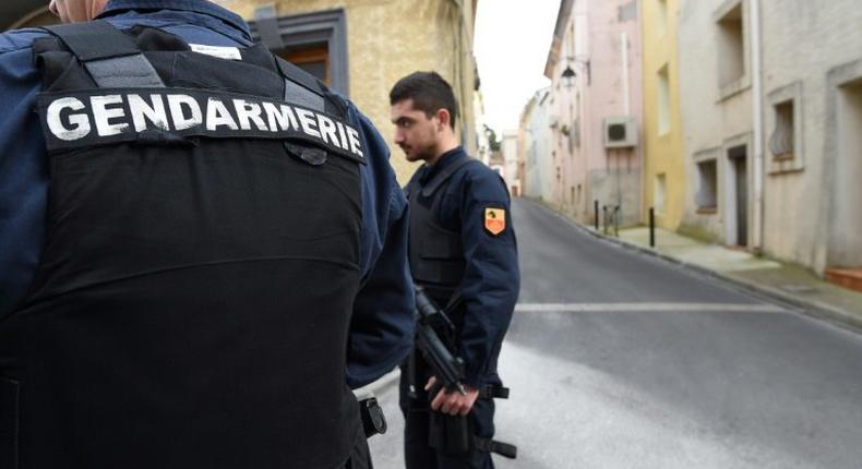 Gendarmes stand guard in a street of Marseillan in southern France, on February 10, 2017, where suspects believed to be involved in plotting an attack were arrested by French anti-terrorist police