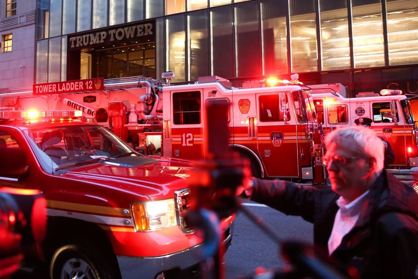 Damaged windows are seen after a fire in a residential unit at Trump Tower in New York