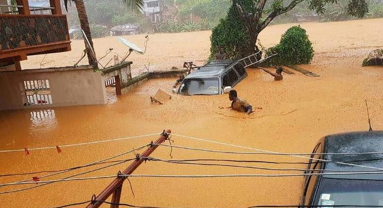 Residents struggled to traverse roads that were turned into churning rivers of mud after Sierra Leone's capital of Freetown was struck by heavy rains