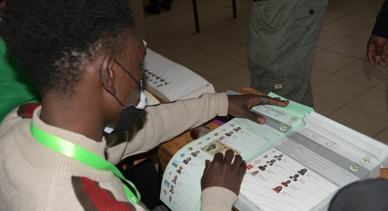 An IEBC clerk issues ballot papers to a voter during the 2022 General Election on August 9, 2022