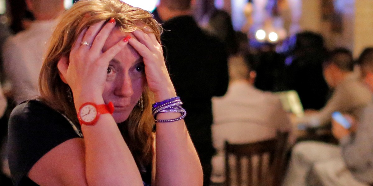 People gathered in The Churchill Tavern, a British themed bar, react as the BBC predicts Britain will leave the European Union, in Manhattan.