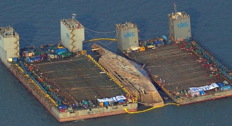 The damaged Sewol ferry was held afloat between two barges during a salvage operation off the South Korean island of Jindo, on March 23, 2017