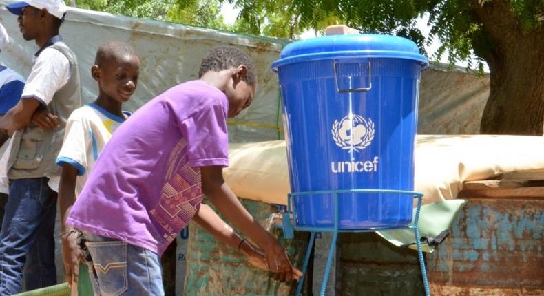 Children wash their hands in a camp for internally displaced people in Diffa, Niger, on August 17, 2016