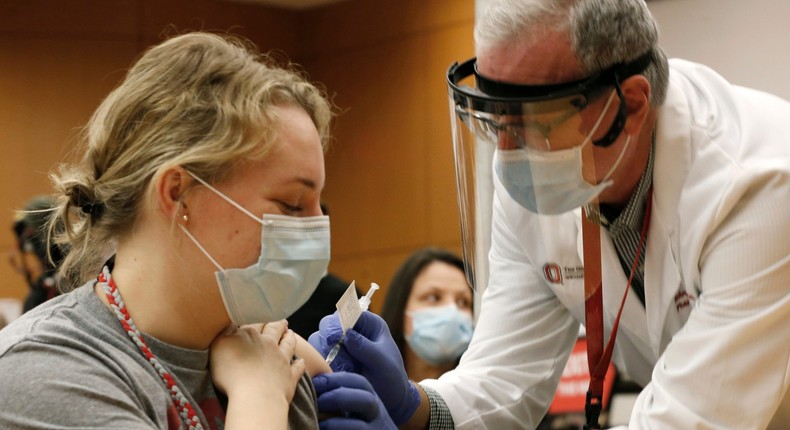 The Ohio State employee Lauren Chisholm receiving a Pfizer-BioNTech COVID-19 vaccination from Robert Weber.