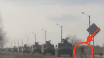 A video appears to show a Ukrainian man trying to block a Russian military convoy.