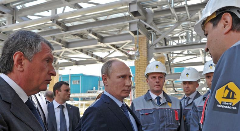 Russian President Vladimir Putin, center, speaks to workers while visiting the Rosneft oil refinery in the Black Sea port of Tuapse, southern Russia.