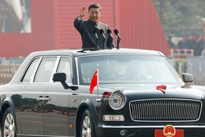 Chinese President Xi Jinping waves from a vehicle as he reviews the troops at a military parade marking the 70th founding anniversary of People's Republic of China