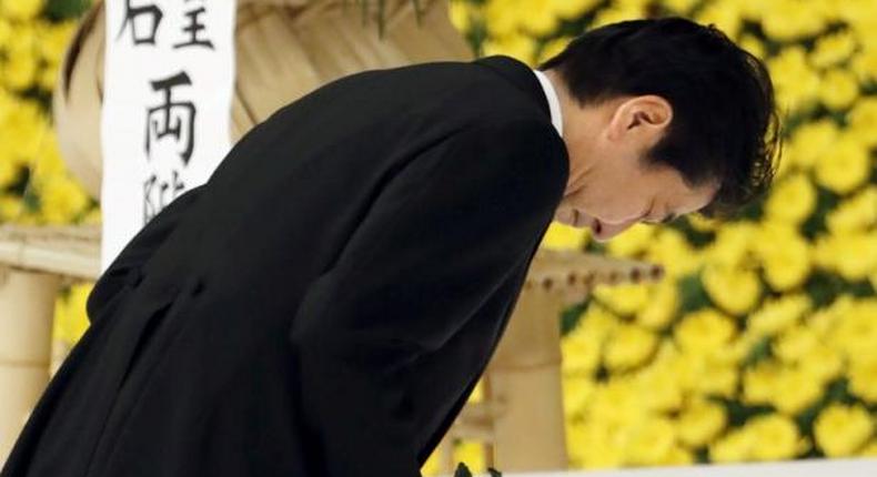 apan's Prime Minister Shinzo Abe bows as he offers a chrysanthemum flower to the war dead during a memorial service ceremony marking the anniversary of Japan's surrender in World War Two at Budokan Hall in Tokyo, Japan, in this photo taken by Kyodo August 15, 2016. 