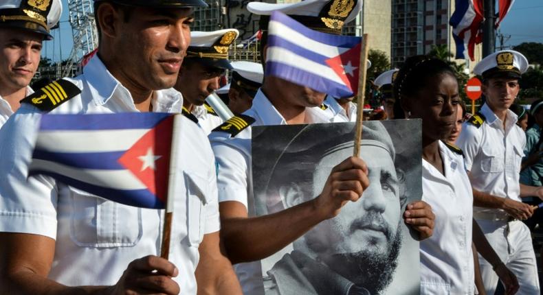 Members of the Navy display a picture of Cuban former president Fidel Castro during the May Day parade at Revolution Square in Havana, on May 1, 2016