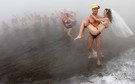 Sergey Kaunov carries his bride Irina Kuzmenko out of water as they celebrate their wedding on the bank of Yenisey River in Krasnoyarsk