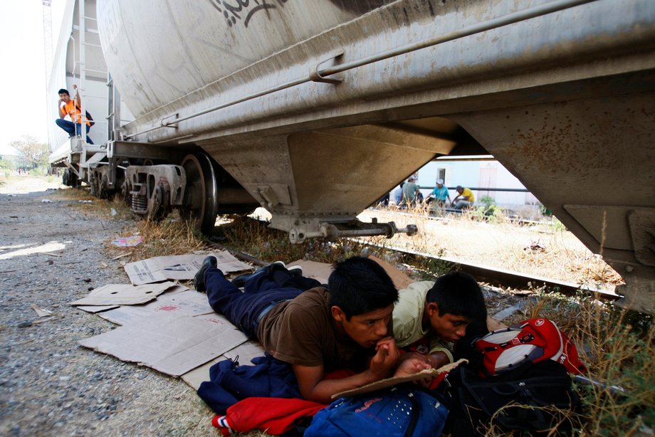 Central American migrants resting next to the train tracks at Arriaga, in the southern Mexican state of Chiapas, while waiting for the freight train "La Bestia," or the Beast, to travel to the US border.