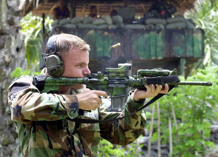 A US Army Ranger test fires his M4 carbine rifle during marksmanship training for Filipino scout rangers taking part in joint military exercises in Isabela, on Basilan Island in the southern Philippines, April 18, 2002.