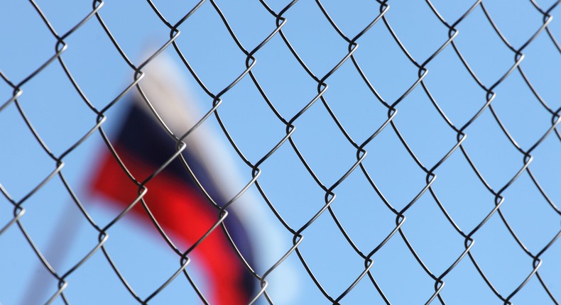 Russian flag behind a fence.