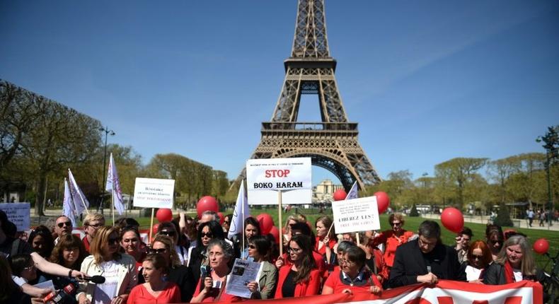 Bring Back Our Girls campaigners rally in front of the Eiffel Tower in Paris in April 2014 