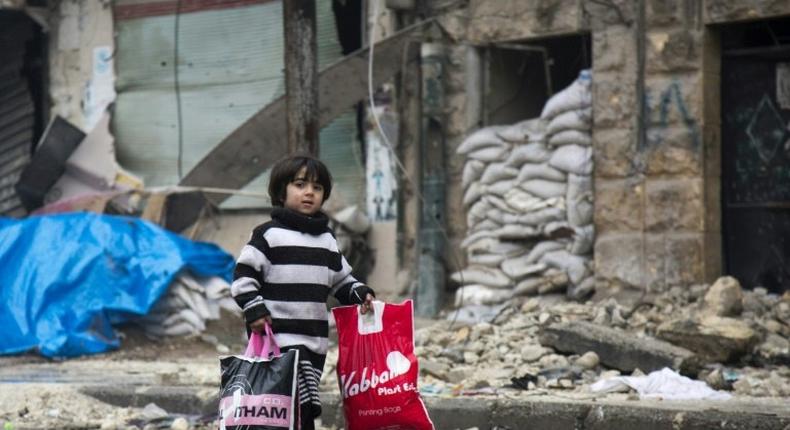 A Syrian boy leave a rebel-held area of Aleppo towards the government-held side on December 13, 2016