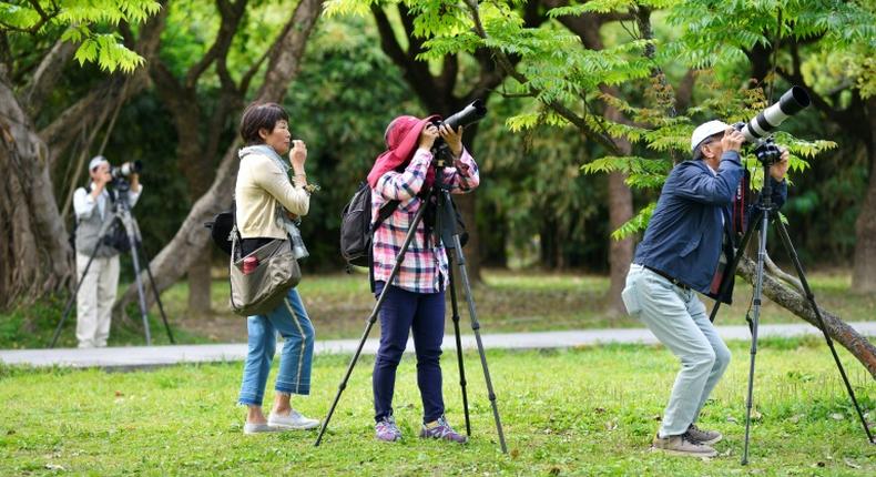 Taiwan bird watchers taking photos at the Da'An Forest Park in Taipei. A Taiwan bird protection group has been ejected from a global body because it refused to sign a statement saying it would never advocate for the island's independence
