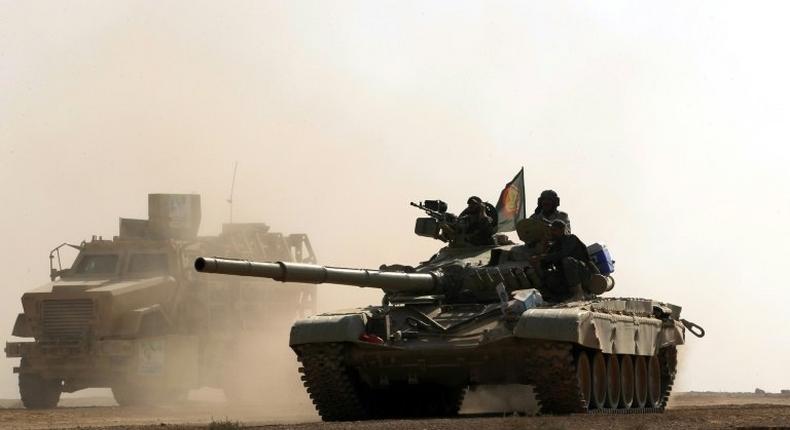 An Iraqi tank advances towards the village of Salmani on the outskirts of Mosul