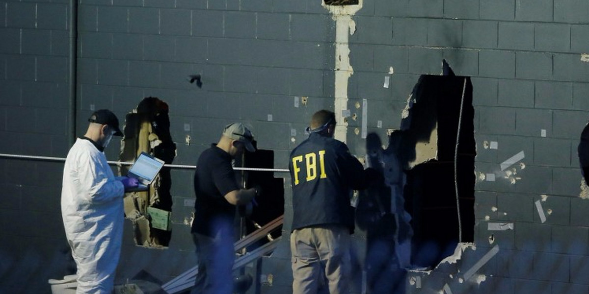 FBI investigators work at the scene of a mass shooting at the Pulse gay nightclub in Orlando, Florida.