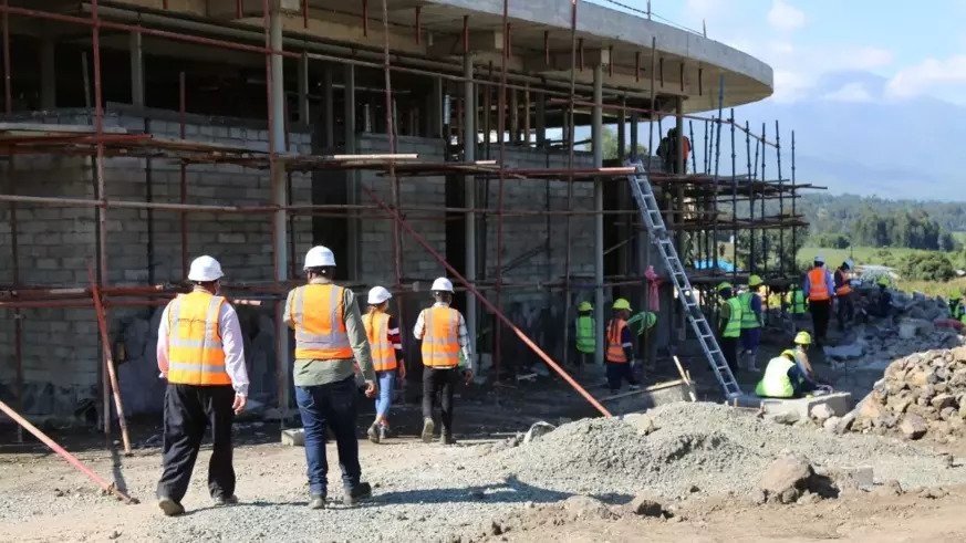 Workers during the ongoing construction activities at Ellen DeGeneres campus in Musanze in June 2021. 
