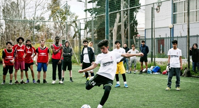 Going for goal: Jawad Ahmadi takes a penalty kick during a tournament with teams composed of refugees and European volunteers in Athens