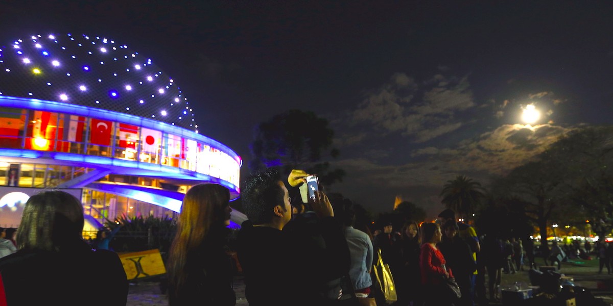 People outside Buenos Aires, Argentina's planetarium see the supermoon on September 27, 2015.