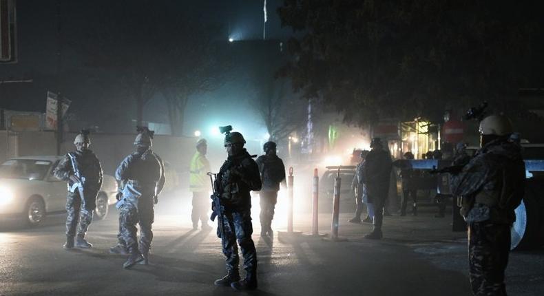 Afghan Crisis Response Unit personnel stand guard at the site of a bomb attack on the Spanish embassy compound in Kabul on December 11, 2015