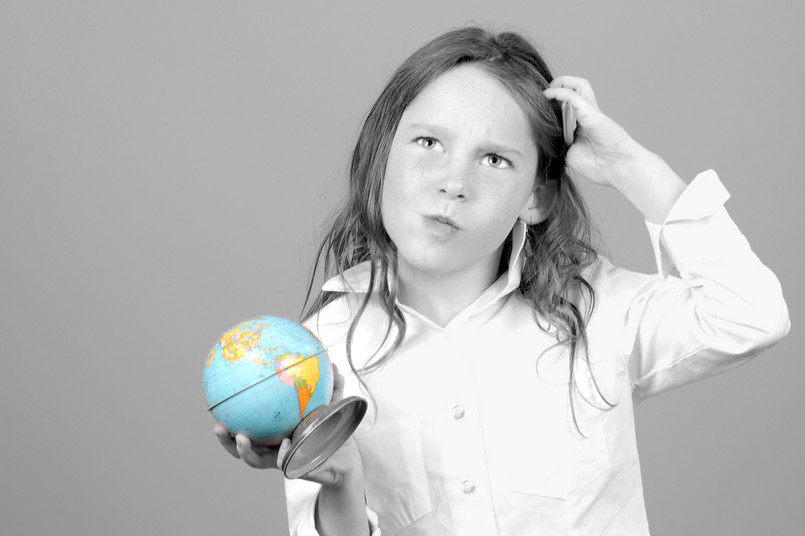 Young,Girl,Looking,Confused,While,Holding,Globe