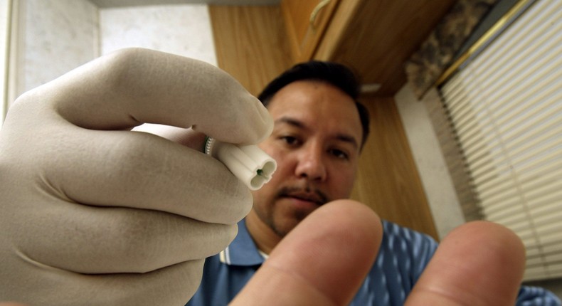 A blood sample is taken for a mobile HIV screening lab.
