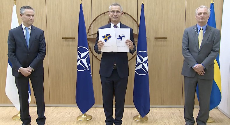 NATO Secretary General Jens Stoltenberg (center) with Finland and Sweden's ambassadors to NATO, Klaus Korhonen and Axel Wernhoff, after receiving their countries' applications to join the bloc on May 18, 2022.