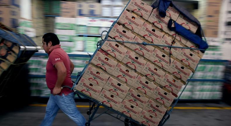 A worker pulls a cart at the Central de Abasto wholesale market in Mexico City on January 14, 2019