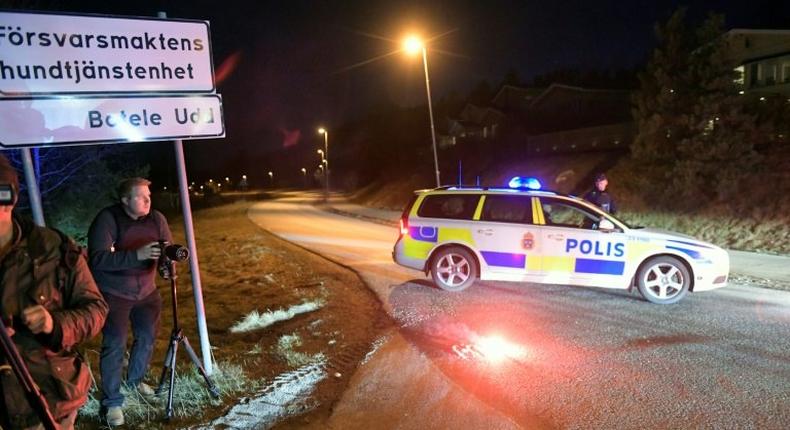 Journalists work at a police checkpoint in Marsta, north Stockholm, on April 7, 2017 after a man suspected of being involved in the truck attack in central Stockholm was arrested